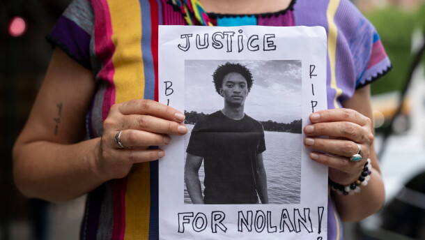 FILE - A person holds a picture of Nolan Xavier Wells during a news conference at National Action Network headquarters, Friday, July 10, 2026, in New York. (AP Photo/Yuki Iwamura, File)