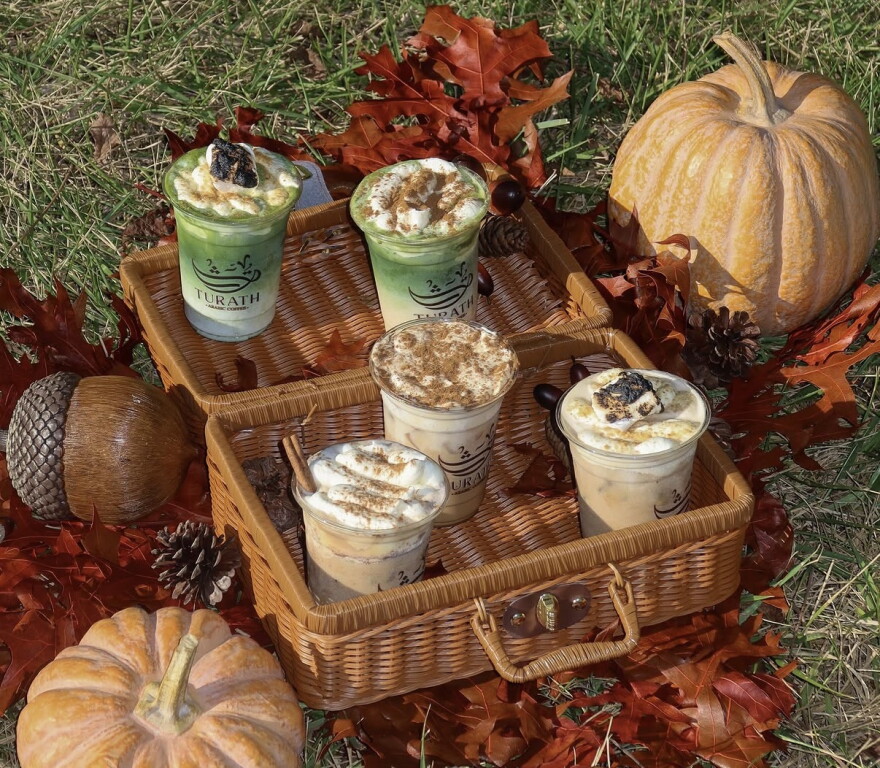 An autumn-styled setting with coffees in a basket