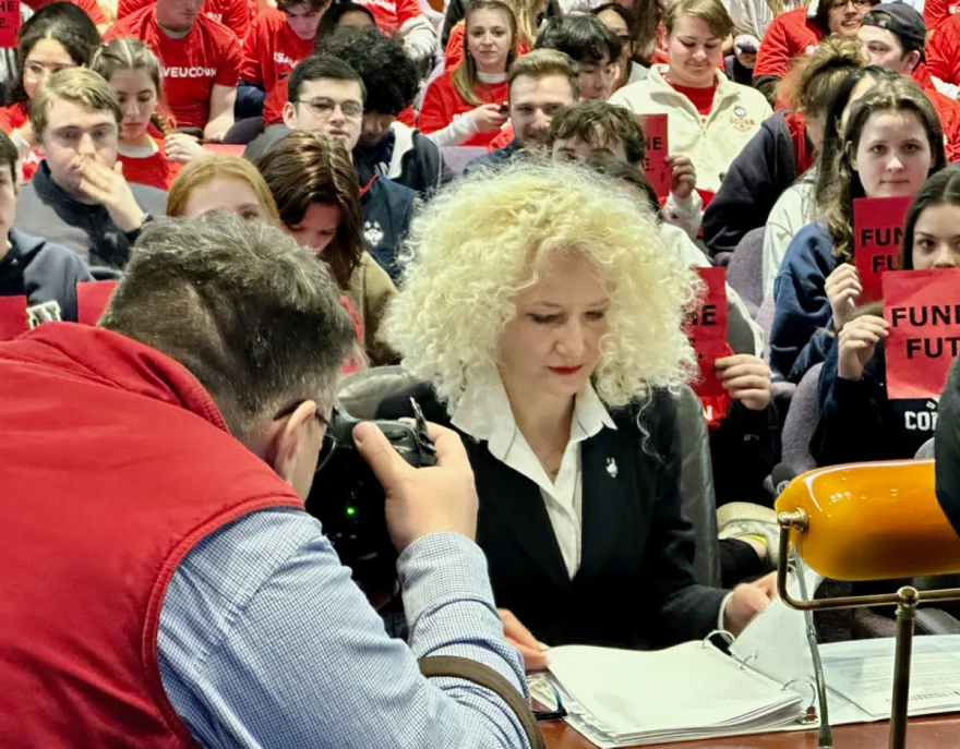 Photographers swarmed UConn President Radenka Maric as she prepared to testify to the Appropriations Committee, backed by students.