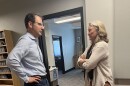 Colorado Attorney General Phil Weiser and KSUT Executive Director Tami Graham talk in the hallway at KSUT studios on Sept. 11, 2025.