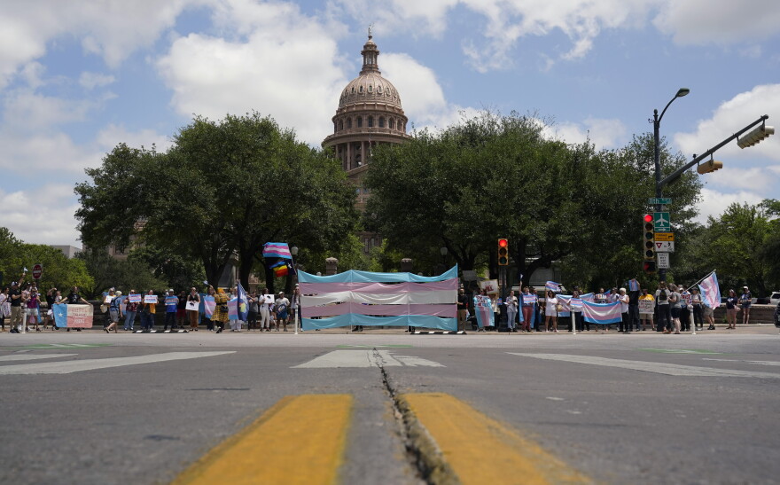 Demonstrators gather on the steps to the State Capitol to speak against transgender related legislation bills being considered in the Texas Senate and Texas House, Thursday, May 20, 2021, in Austin, Texas. (AP Photo/Eric Gay)
