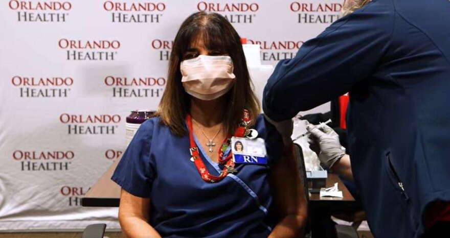 A nurse at Orlando Health receives the first dose of a coronavirus vaccine. Photo courtesy of Orlando Health.