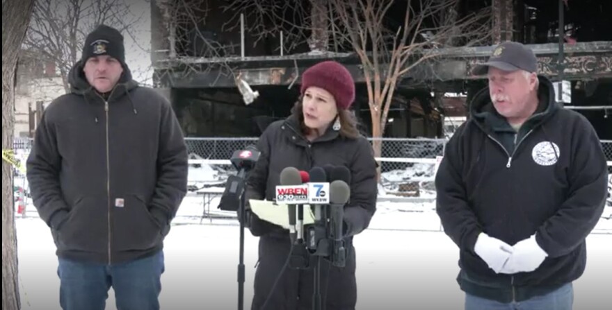 Catherine Amdur, Commissioner of Permit & Inspection Services in front of microphones at the site of the deadly fire on 745 Main St