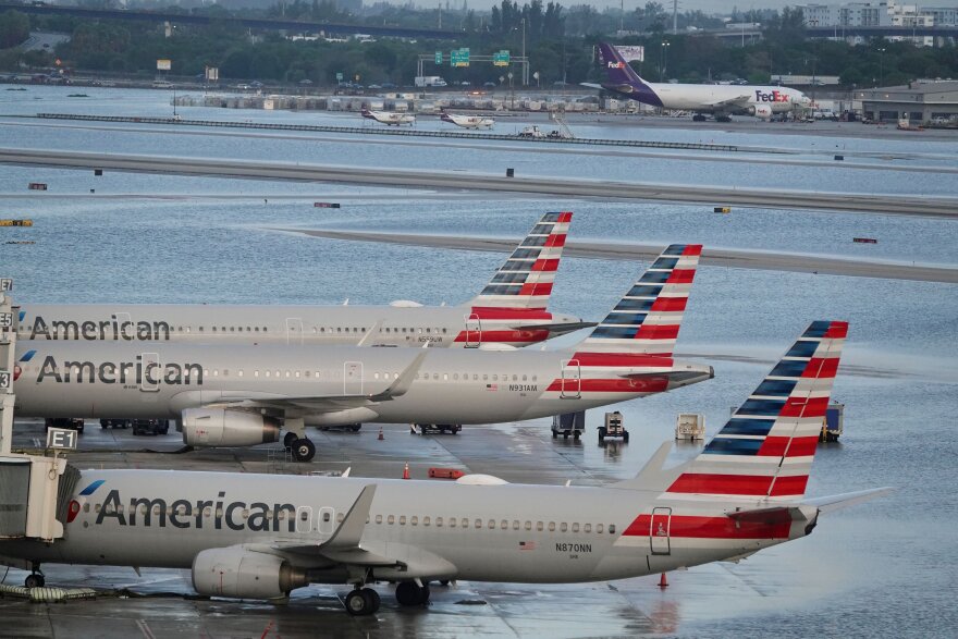 American Airlines airplanes sit on the tarmac as flooding lingers at Fort Lauderdale-Hollywood International Airport on Thursday, April 13, 2023 after heavy rain pounded South Florida on Wednesday. 