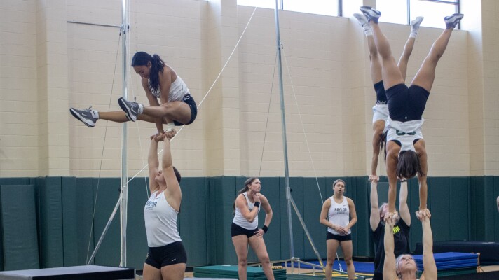 Members of the Baylor Acrobatics and Tumbling team practice coordinated lifts during a practice session in September.