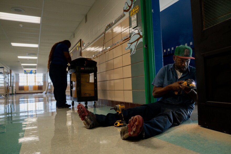 St. Louis Public Schools worker Alex Graves woodworks on a door at Washington Montessori Elementary School on Wednesday, Nov. 5, 2025, in north St. Louis.