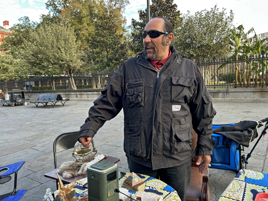Card-reader Dinos, pictured here in New Orleans' French Quarter on Jan. 20, 2025, believes the National Guard presence may make people feel safer.