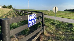 An anti-data center sign is across the street from farmland where a massive hyperscale data center has been proposed in rural Mercer County.
