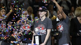 UConn's Paige Bueckers, center, holds the Most Outstanding Player trophy after the school defeated Creighton in an NCAA college basketball finals game of the Big East Conference tournament, Monday, March 10, 2025, in Uncasville, Conn. (AP Photo/Jessica Hill)
