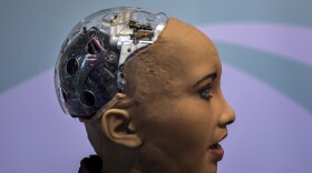 Hanson Robotics' flagship robot Sophia, a lifelike robot powered by artificial intelligence, speaks with visitors, at the Mobile World Congress wireless show, in Barcelona, Spain, Tuesday, Feb. 26, 2019. (Emilio Morenatti/AP)