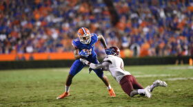 Florida wide receiver Demarcus Robinson (11) stiff-arms New Mexico State defensive back Winston Rose (4) after catching a pass.