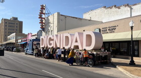 People pose with the sculpture "Dignidad" on Jefferson Boulevard in Oak Cliff.