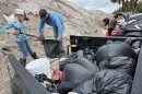Sent from my iPhone Andrew Lafreniere gets help from, Coltin Drinnen, 8, to fill garbage bags with sand Monday afternoon on Manasota Key. They had to fill 40 bags.