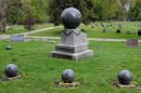 Several graves are shown inside a cemetery.