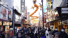 Visitors stroll a street decorated with a big dragon shaped lantern for their Chinese Lunar New Year celebration which marks the Year of the Snake on the Chinese zodiac Wednesday, Jan. 29, 2025, at China Town in Yokohama, south of Tokyo. (AP Photo/Eugene Hoshiko)