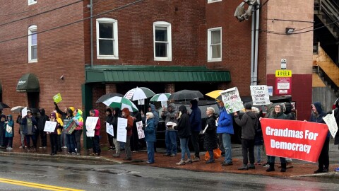 Protestors outside Senator Angus King's office on Pleasant Street in Portland on Monday.