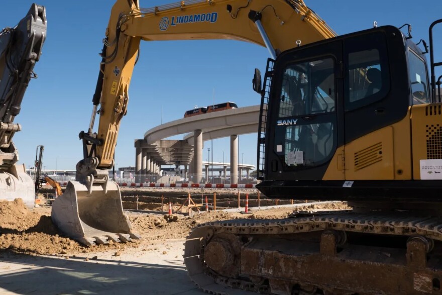 Construction equipment digs into the ground at the DFW Airport.