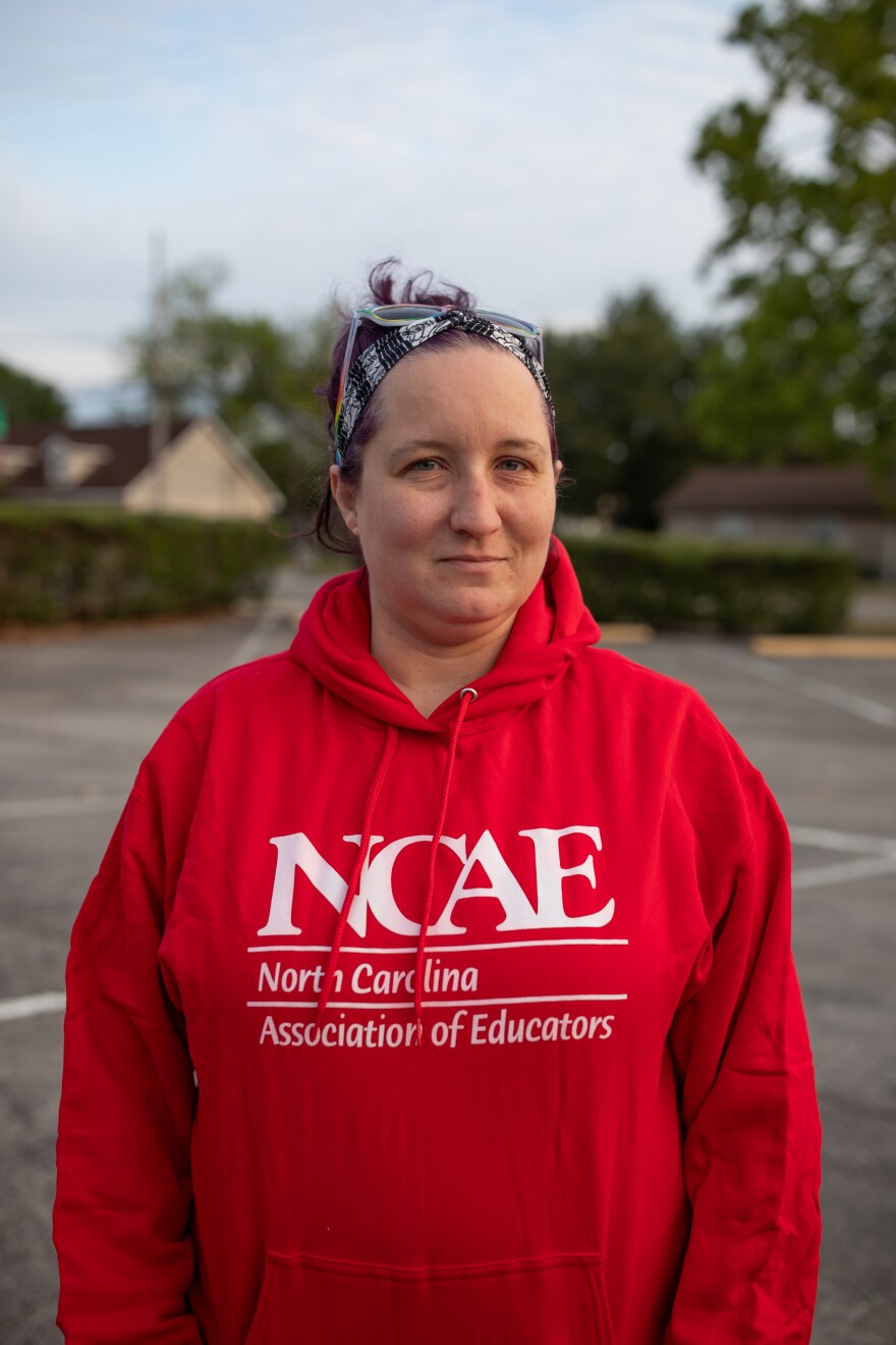 New Hanover County Schools teacher and President of NHCAE, Jacqui Dalessio, prepares to board a bus to Raleigh for the 'Kids Over Corporations' rally organized by the North Carolina Association of Educators on May 1, 2026. North Carolina is currently ranked 46th in the country for teacher pay.