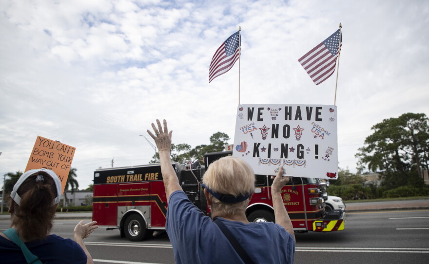 People gather along U.S. 41 in Fort Myers on Saturday morning, October 17, 2026, to advocate for change ahead of the mid-term elections. Organizers estimate about 1,000 people came out for the event.