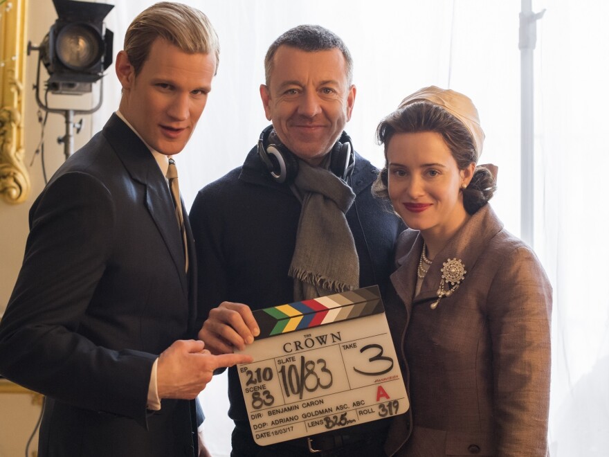 Peter Morgan (center) poses with Matt Smith, who plays Prince Philip, and Claire Foy, who plays Queen Elizabeth II, on the set of <em>The Crown.</em> Morgan also wrote the screenplays for <em>The Queen</em> and <em>Frost/Nixon.</em>