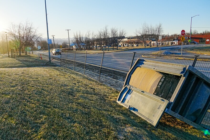 a portable toilet lies on its side
