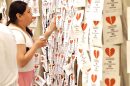 A young woman places a paper on the door to the Governor's Office to oppose House Bill 4156. The papers read, "You chose politics over people. You broke my heart." Hundreds gathered at the Oklahoma State Capitol to oppose the new immigration law during Hispanic Cultural Day on May 15, 2024.