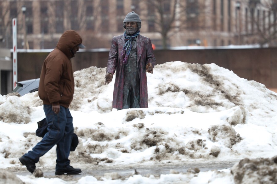 The Frederick Douglass statue on State Street stands tall amid the snow piles.