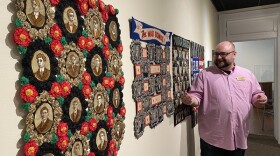 Jason French, curator of collections at the Behringer Crawford Museum points out Rebekka Seigel's series of quilts called The Real Cost of War