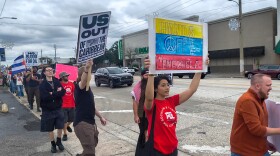 People march through Orlando’s Mills 50 neighborhood on Saturday in protest of the United States’ military intervention in Venezuela.