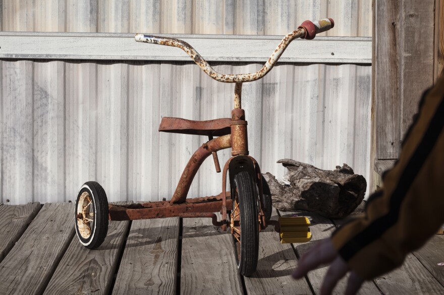 An old tricycle on the Cunninghams' front porch.