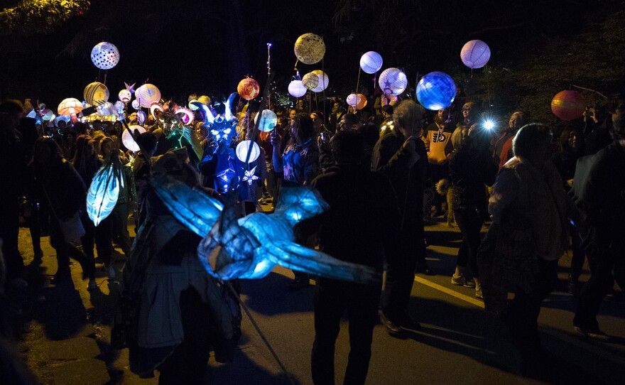 Parade goers march during the Luminata lantern parade on Thursday, September 21, 2017, at Green Lake in Seattle. 