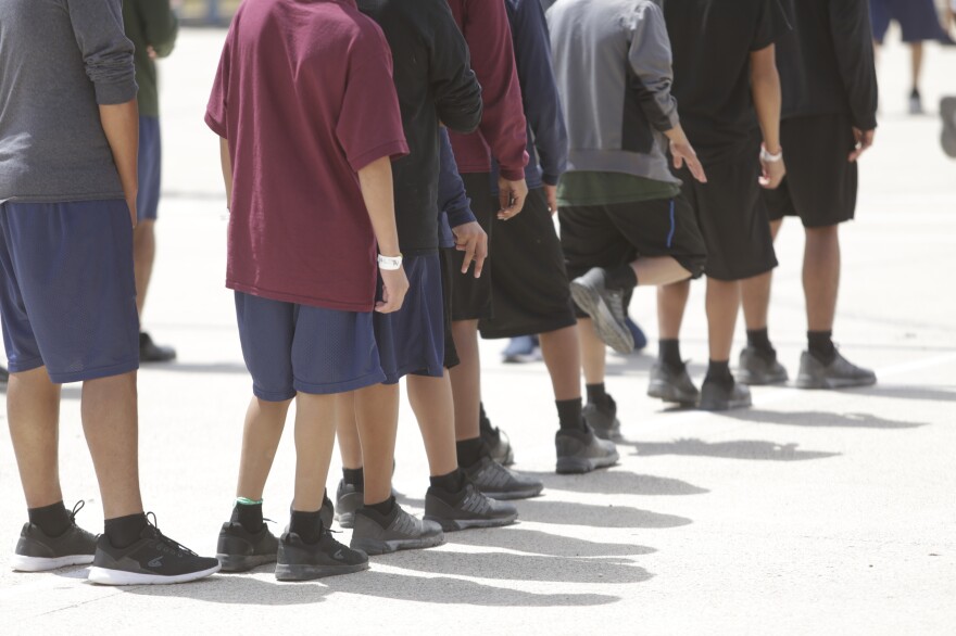 Boys 10 to 17 years old stand outside a government-contracted youth shelter in Brownsville, Texas. Ninety percent of the residents<strong> </strong>traveled to the United States alone seeking protection; the remainder were separated from their families at the border under a controversial new policy by the Trump administration.