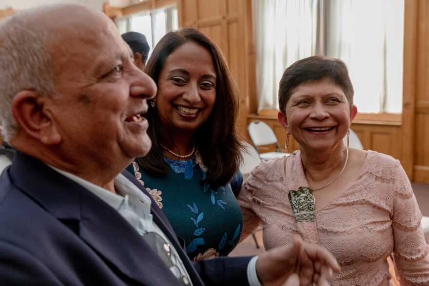 Juthani, center, and her parents, Dr. Virendra Juthani, left, and Dr. Nalini Juthani, talk to Gov. Ned Lamont after Juthani was nominated as public health commissioner. Her parents immigrated from India in 1970.