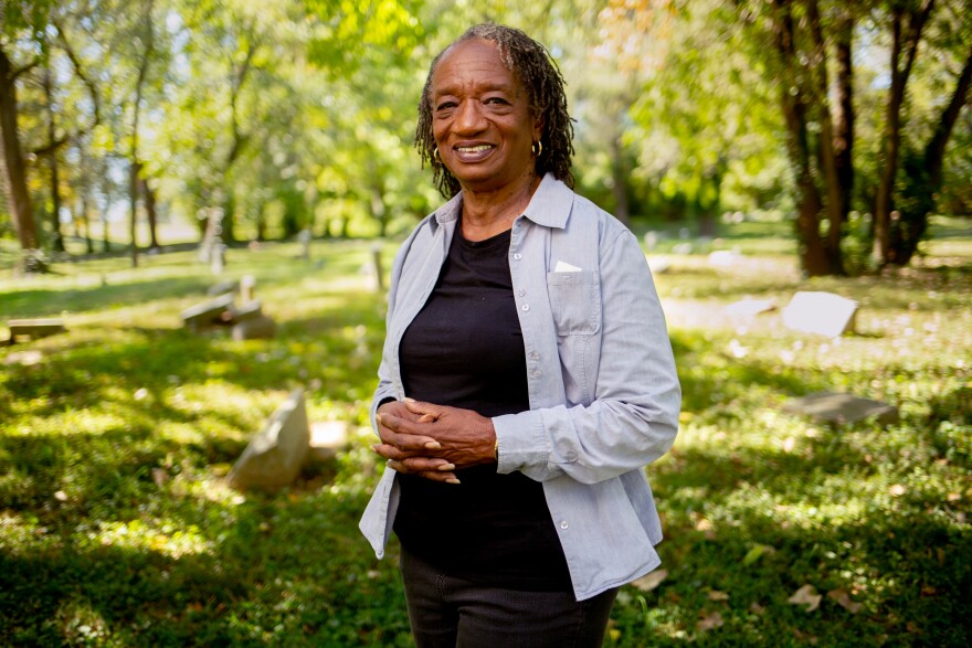 Etta Daniels smiles for a portrait at a cemetary