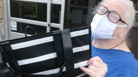 Clare Skeehan holds up her reusable bag she was unable to use on her grocery shopping trip.
