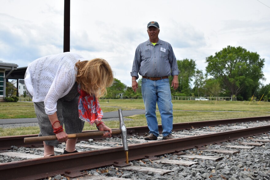 Mayor Amy Marasco takes her swing at the ceremonial golden spike.
