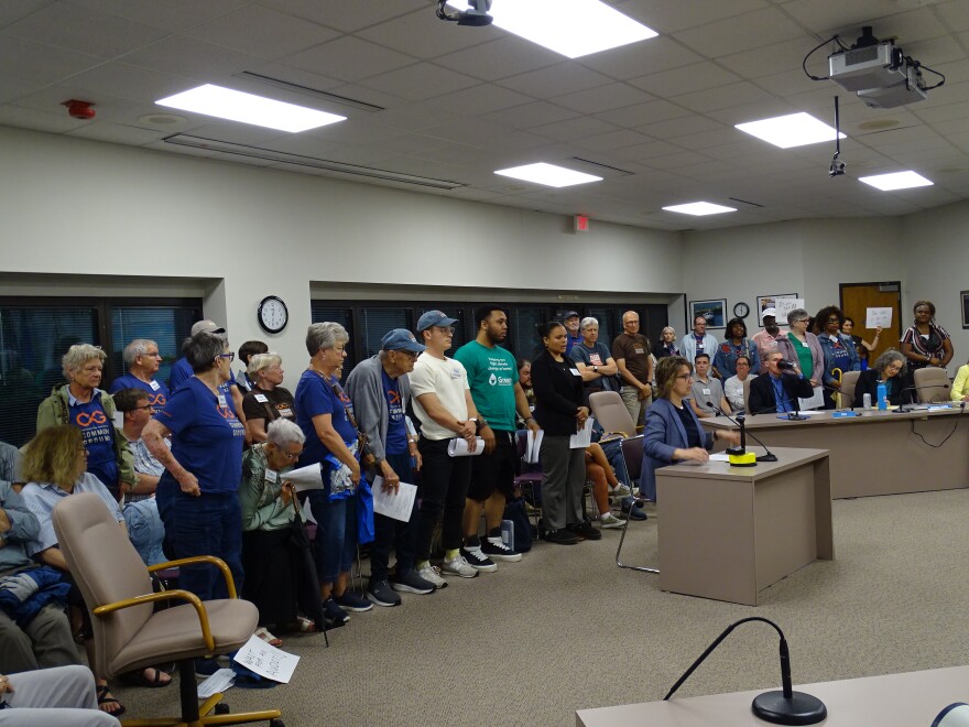 Common Ground executive director Jennifer O'Hear was flanked by members of the advocacy group as she spoke at Thursday's public hearing.