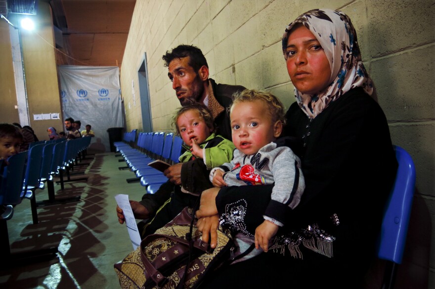 Um Ahmed, her husband, Abu Ahmed, and their two children sit inside a United Nations refugee registration center in Tripoli, Lebanon. They fled the northern Syrian city of Aleppo a month ago. "There was a lot of shelling," said Um Ahmed. "I wasn't thinking. I was just thinking of my children."