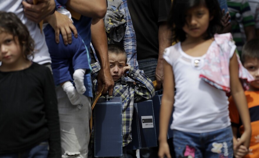 Immigrant families seeking asylum walk to a respite center after they were processed and released by U.S. Customs and Border Protection, Friday, June 29, 2018, in McAllen, Texas.