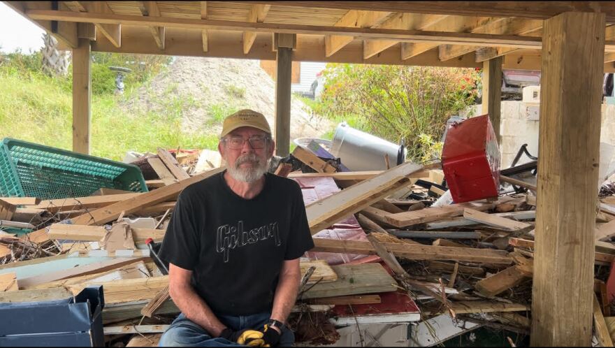 Jim Wilcox sits under his house. Cedar Key is a town of “survivors,” he said. (Grace McClung/WUFT News)