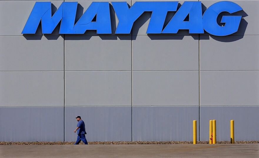 A lone Maytag employee walks across a deserted company parking lot Thursday, Sept. 16, 2004, in Galesburg, Ill. 