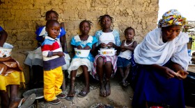 Mamuedeh Kanneh (right) was married to the man who brought Ebola to Barkedu, Liberia, a village of about 6,000. He died of the virus. She now cares for her children as well as children who lost their parents to the disease.