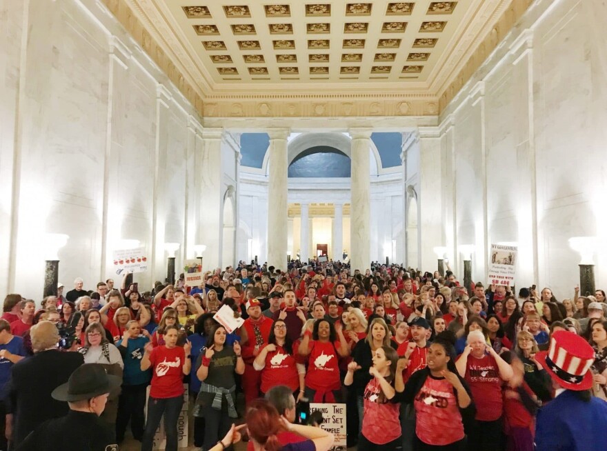 Teachers celebrate after West Virginia Gov. Jim Justice and Senate Republicans announced they reached a tentative deal to end a statewide teachers' strike by giving them 5 percent raises in Charleston, W.Va., Tuesday, March 6, 2018. (Robert Ray/AP)