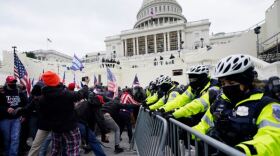 Trump supporters try to break through a police barrier at the Capitol in Washington, D.C., on Wednesday. As Congress prepares to affirm President-elect Joe Biden's victory, thousands of people have gathered to show their support for President Trump.