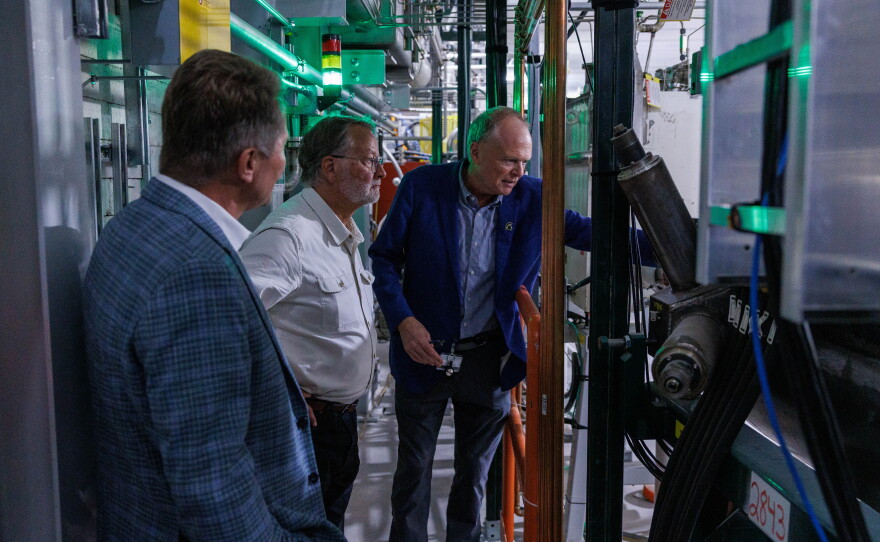 U.S. Sen. Gary Peters, center, visits the Facility for Rare Isotope Beams in East Lansing, Mich., on Aug. 28, 2026. He is joined on the tour by Michigan State University President Kevin Guskiewicz, left, and FRIB Laboratory Director Thomas Glasmacher, right. The visit was the last stop on Peters' final motorcycle tour of Michigan as senator.