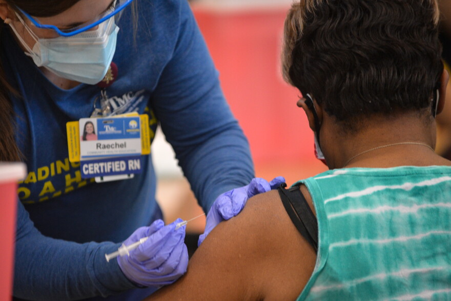 Truman Medical Centers RN Raechel Blades gives Grace Crain her first injection of the Pfizer BioNTech COVID-19 vaccine on Jan. 26 at Morning Star Missionary Baptist Church.