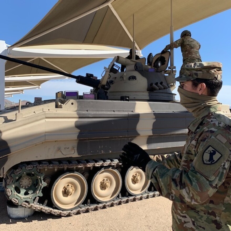 Soldiers at Fort Irwin in California wear masks to protect themselves from the coronavirus. The Army wants to get back to training thousands of troops at a time. Such training has been sidelined by the virus.
