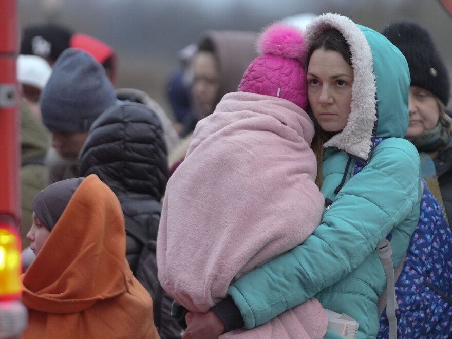 Refugees, mostly women with children, wait for transportation at the border crossing in Medyka, Poland, Saturday, March 5, 2022, after fleeing from Ukraine.