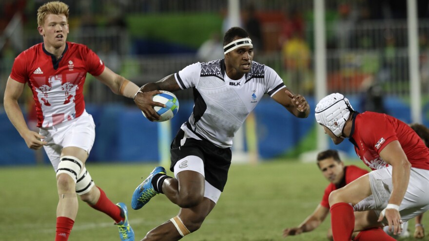 Semi Kunatani of Fiji sprints with the ball in the gold medal match against Britain in men's rugby sevens on Thursday. Fiji routed Britain, 43-7, to win its first gold medal as rugby returned to the Olympics for the first time since 1924.