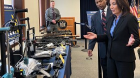 Gov. Kathy Hochul views illegal guns seized in recent raids at the state police Troop G headquarters in Latham on March 4, 2024.